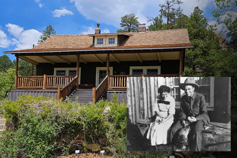A historic cabin with an inset historic photograph of people sitting outside.