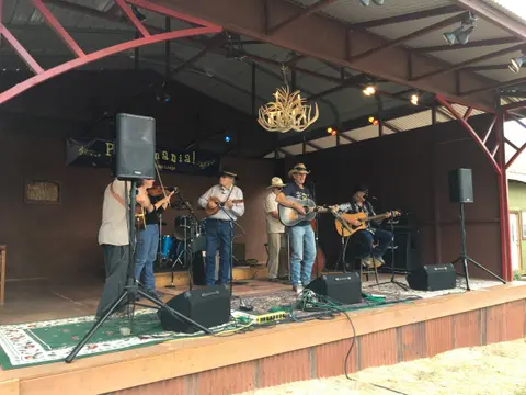 A band plays music on an outdoor stage.
