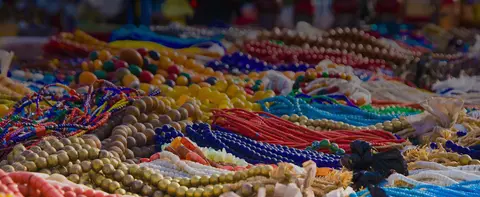 A display of various colorful bead necklaces and bracelets.
