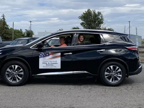 A black SUV with a sign on the side.
