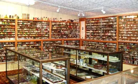 An interior view of a shop or museum filled with shelves and display cases containing a large collection of small objects.