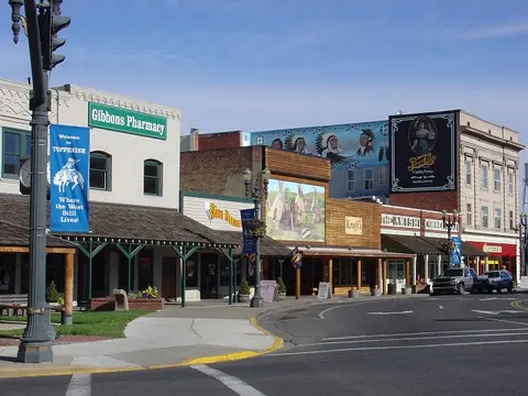 A view of a historic downtown street with old storefronts and murals.