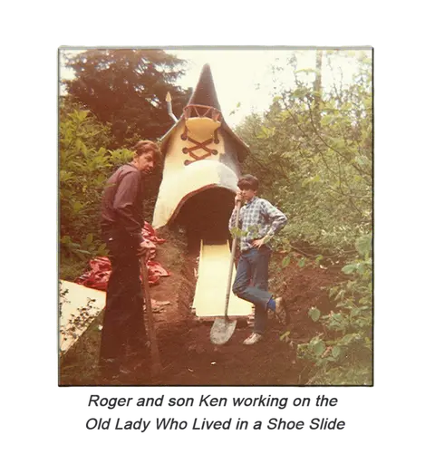 Two people working on a shoe slide structure in a wooded area.