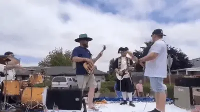 A band plays music outdoors.